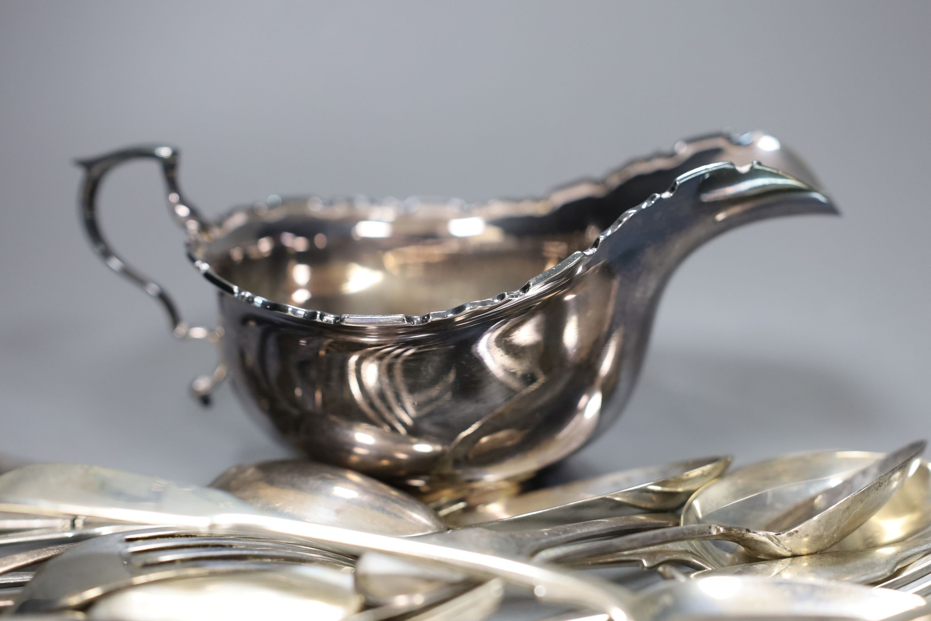 A George V silver sauceboat and a small quantity of assorted mainly 19th century and later silver flatware, 30.5oz and four French white metal tea forks.